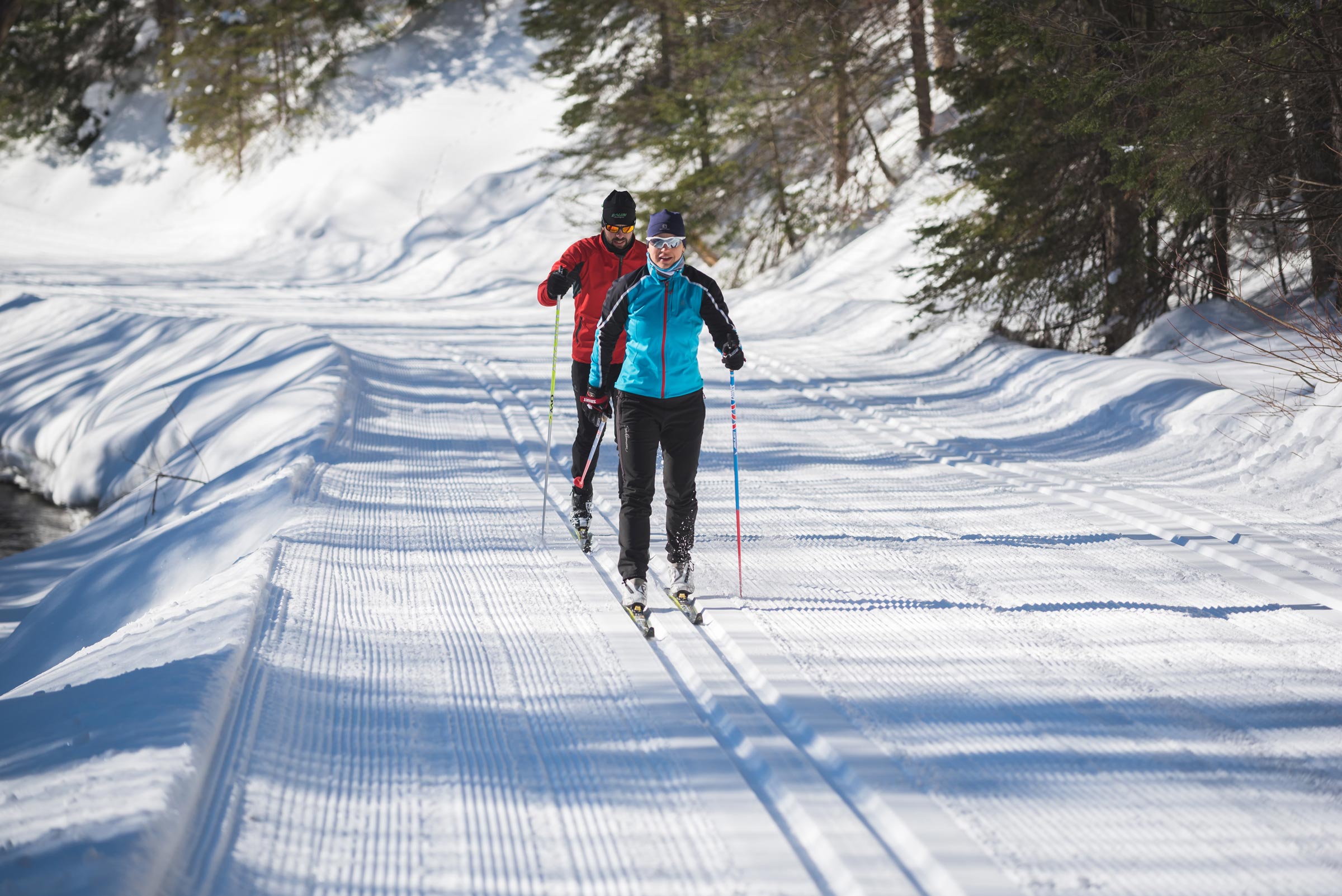 Couple cross-country skiing on a groomed trail at Mont-Sainte-Anne, Québec City area